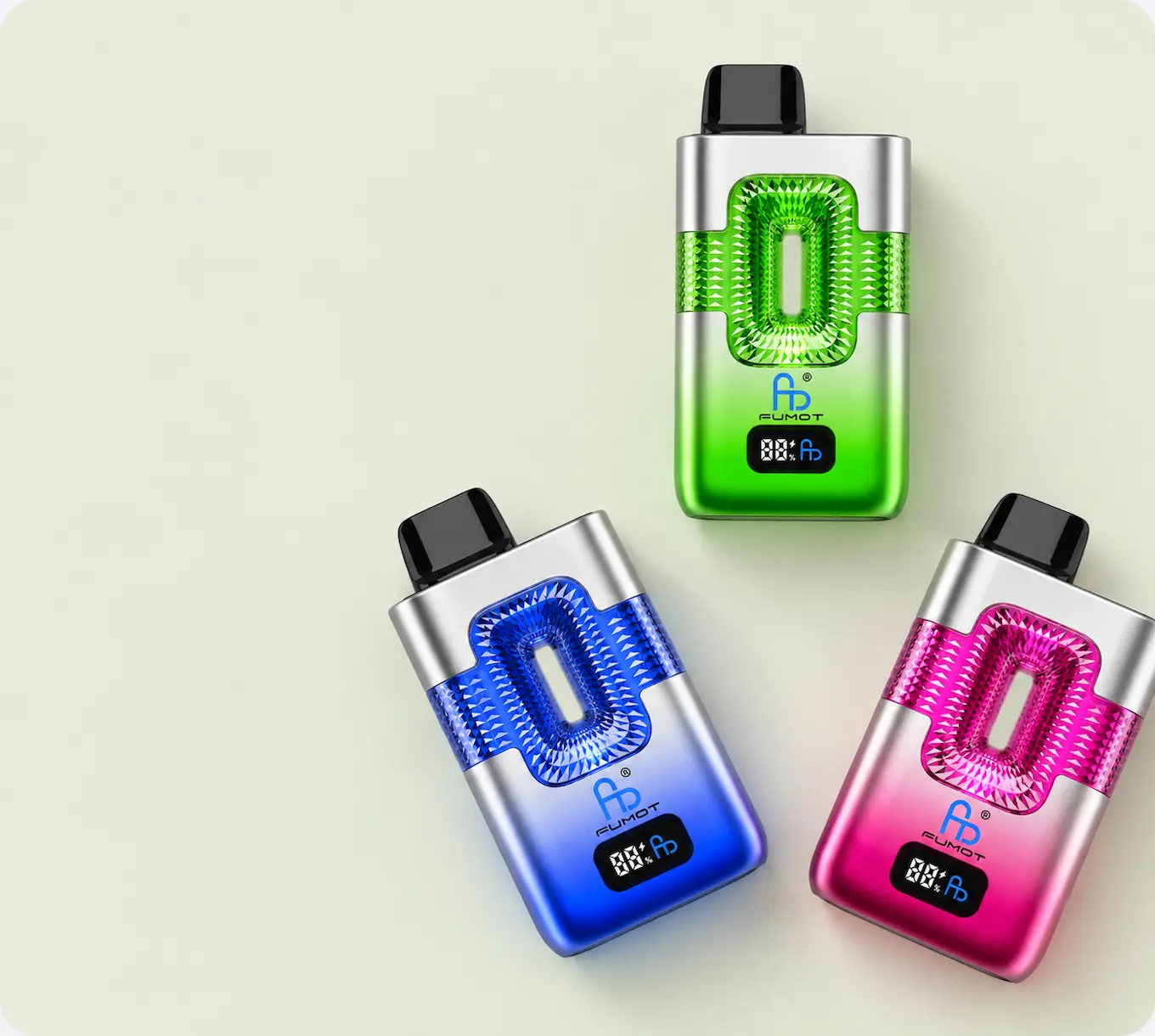 Green, blue and pink FUMOT vapes featuring sparkling crystal-style panels, silver finishes and digital displays.